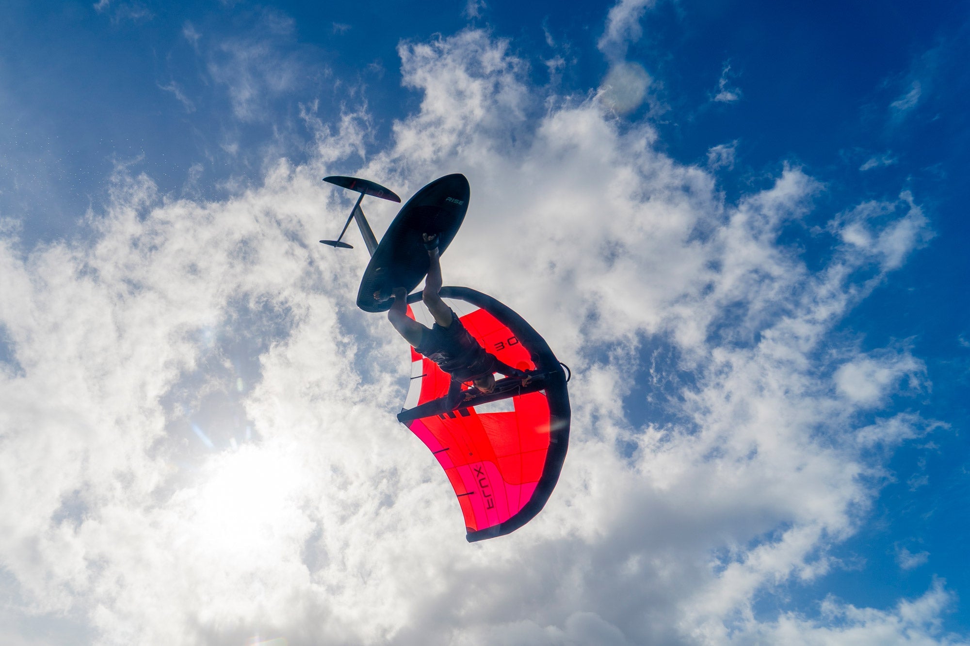Wing foiler riding an Ozone Flux V2 wing on the west coast of Ireland